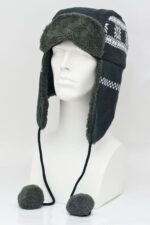 A fur-lined winter hat displays a patterned exterior and extends down the sides with flaps. It rests on a plain mannequin head against a neutral background.