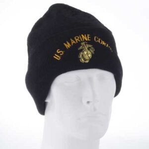 A black beanie hat with gold embroidery displays the text U.S. MARINE CORPS and a logo of an eagle  globe  and anchor placed on a white mannequin head against a plain background.