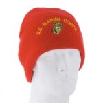 A red beanie hat is displayed on a white mannequin head featuring the embroidered text US MARINE CORPS and a logo  suggesting military affiliation and purpose in casual wear.