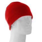 A red knit beanie is displayed on a white mannequin head facing slightly left in a neutral background emphasizing the color and texture of the hat.