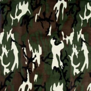 A patterned fabric featuring a combination of dark green light green and white shapes resembling flames or abstract forms against a brown background creating a camouflage appearance.