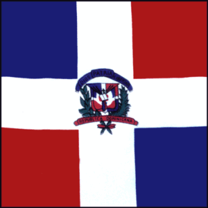 A flag features a large white cross on a blue and red background with the national coat of arms in the center displaying a shield and a scroll inscribed with Dios Patria Libertad and República Dominicana.