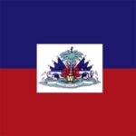 A rectangular flag features two horizontal stripes in blue and red with a central white rectangle displaying a coat of arms that includes a palm tree and cannons symbolizing Haiti.