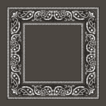 A decorative black and white paisley patterned border surrounds an empty central space creating a contrast against the dark background ideal for framing images or text.