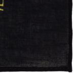 A black fabric object lies flat with a textured surface and a partially visible edge suggesting it is designed for versatile use in clothing or accessories.