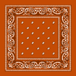 A square fabric features a bold orange background adorned with intricate white paisley designs along the edges and small white drop shapes scattered throughout the center.