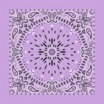 A lavender bandana features intricate black and white paisley patterns radiating from the center towards the edges creating a symmetrical design against a solid lavender background.