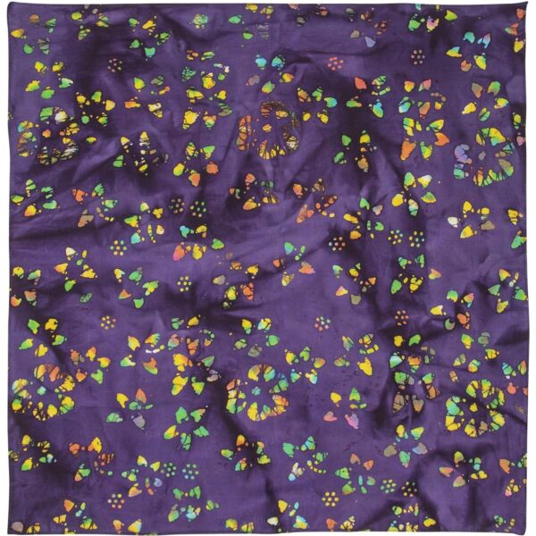 A vibrant purple fabric displays a pattern of multicolored butterflies and dots creating a lively and decorative texture. The fabric appears slightly wrinkled  enhancing its visual interest.