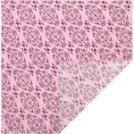 A patterned fabric with a pink background features intricate brown floral designs covering the surface while a corner reveals a lighter version of the same pattern