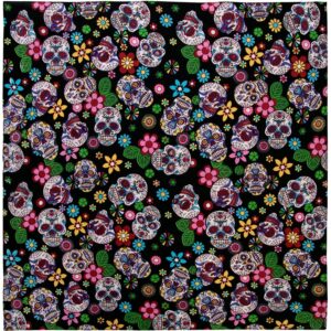 A vibrant fabric covered with intricate skull designs surrounded by colorful flowers and leaves set against a black background creating a festive and lively pattern.