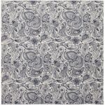 A patterned fabric featuring intricate paisley and floral designs in dark blue and white covers the surface  designed for decorative or textile use in a variety of contexts.