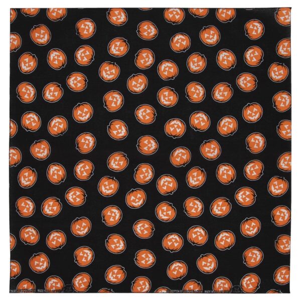A patterned fabric features multiple orange jack-o'-lanterns with various facial expressions set against a solid black background creating a festive Halloween theme throughout the material.