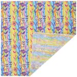 A vibrant fabric displays vertical stripes in blue and yellow with floral patterns in pink and purple The fabric is partially folded revealing a contrasting design underneath in softer pastel colors
