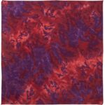 A square piece of fabric displays a vibrant pattern of reds and purples with swirling and abstract designs creating a dynamic visual effect suitable for artistic or decorative use.