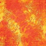 A vibrant square bandana featuring shades of orange and yellow with intricate paisley patterns along the borders creating a warm and lively textile design suitable for fashion or decoration.
