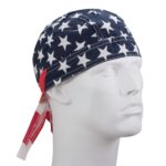 A fabric cap features a design of white stars on a navy background with red accents sitting on a white mannequin head against a plain backdrop.