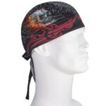 A black bandana-style head wrap features a skull design with flames and tribal patterns. It is worn on a mannequin's head  positioned upright against a plain background.
