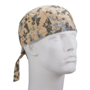 A camouflaged fabric bandana is displayed on a white mannequin head The bandana features a digital pattern in beige gray and black colors with ties at the back