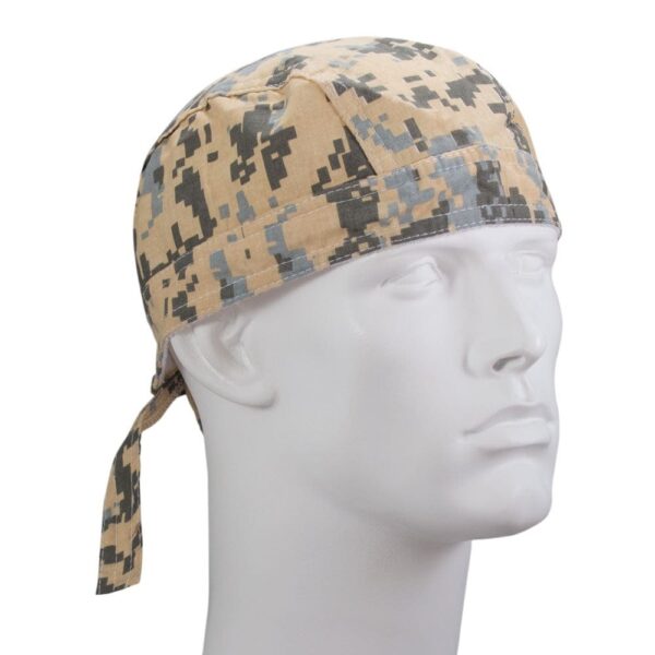 A camouflaged fabric bandana is displayed on a white mannequin head The bandana features a digital pattern in beige gray and black colors with ties at the back