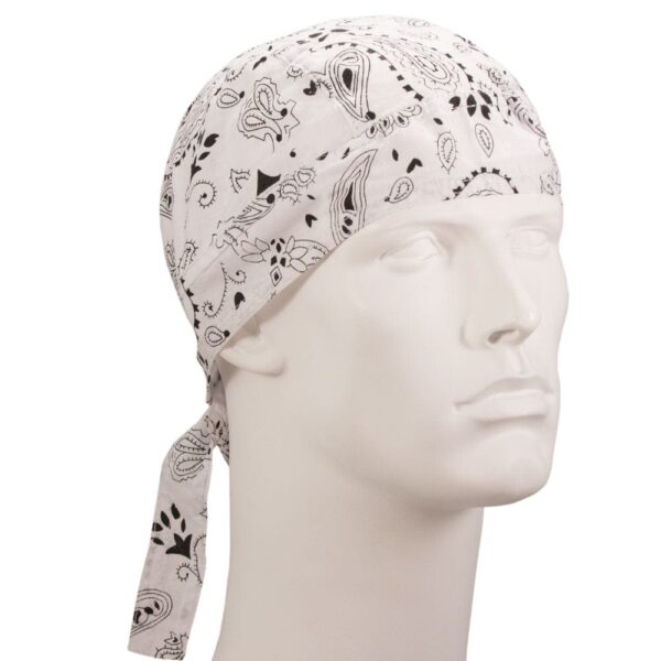 A white bandana with black paisley patterns is tied around a mannequin’s head  resting snugly in place  showcasing its design in a neutral setting against a plain background.