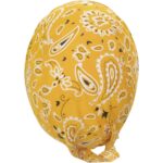 A yellow bandana featuring a white paisley pattern is tied in a knot at one end resting on a flat surface showcasing its vibrant color and intricate design.