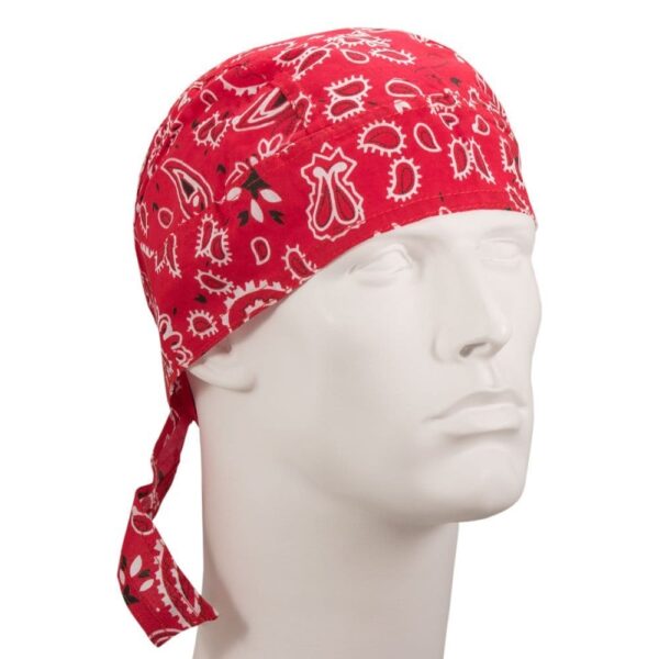 A red bandana with white patterns is tied around a mannequin's head showcasing a stylish look in a neutral setting emphasizing the bandana's vibrant color and design.