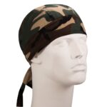 A camouflage bandana is placed on a mannequin's head with the ties hanging down its side suggesting a casual or adventurous style in a neutral background.