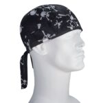 A black bandana features white skull and crossbones designs. It is tied at the back  resting on the head of a plain white mannequin bust facing slightly to the right.