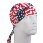 A white mannequin head wears a red white and blue bandana patterned with stars and stripes showing patriotic themes in a neutral setting without any distinct background elements.