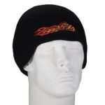 A black knit beanie is displayed on a white model head featuring red and yellow flame embroidery across the front suggesting a stylish accessory for colder weather settings.