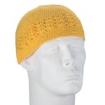 A crocheted yellow hat sits on a stylized mannequin head facing slightly to the left showcasing a textured design with an open weave pattern against a plain background.