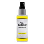 A hand sanitizer bottle sprays liquid sanitizer to sanitize hands. The bottle is clear with a yellow and gray label stating GUARDIAN HAND SANITIZER LIQUID FORMULA 2 fl oz 60 ml.
